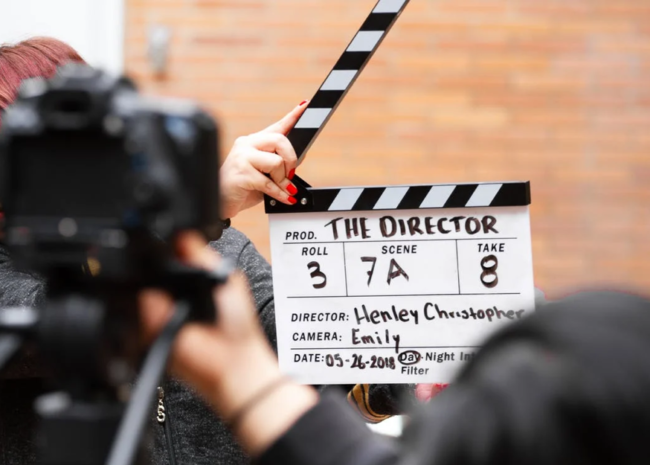 Man holding a clapperboard board